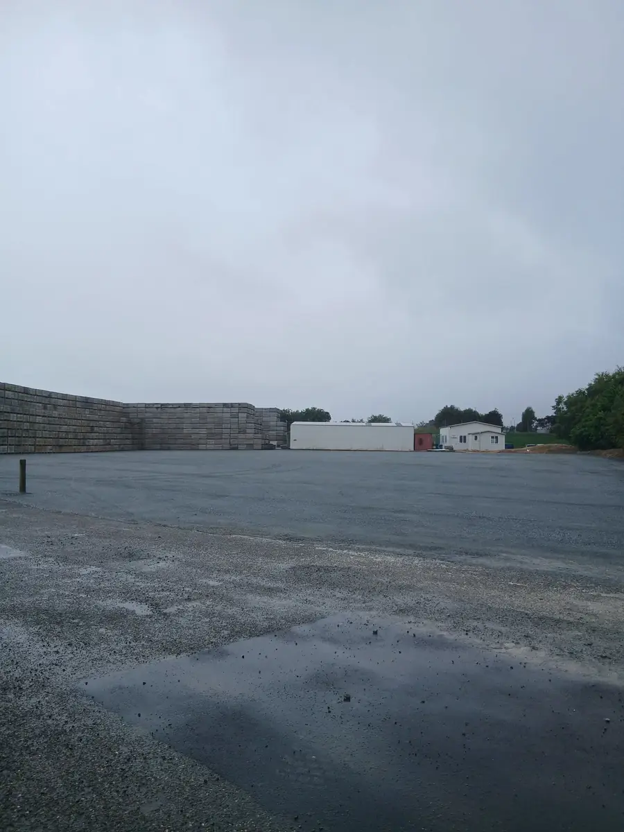 D&R Works yard with stacked bins and site sheds