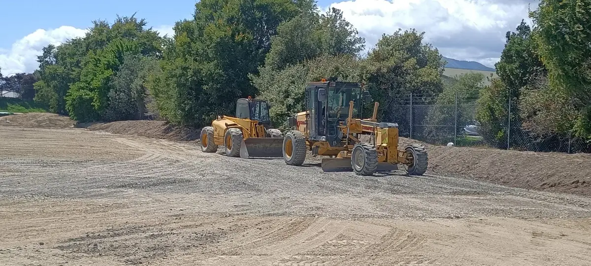 Graders levelling a pad ahead of further civil works
